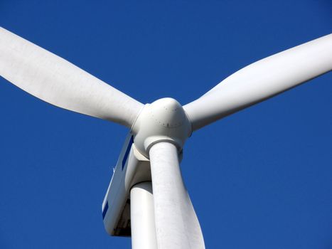 close-up portrait of wind turbine in blue sky