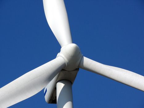 close-up portrait of wind turbine in blue sky