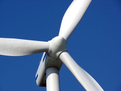 close-up portrait of wind turbine in blue sky