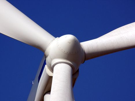 close-up portrait of wind turbine in blue sky