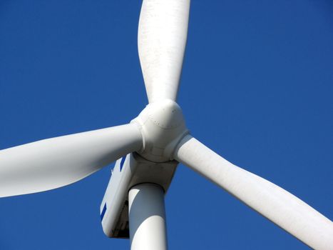 close-up portrait of wind turbine in blue sky