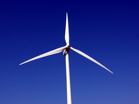 portrait of wind turbine in blue sky