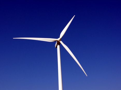 portrait of wind turbine in blue sky