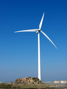 portrait of wind turbine in blue sky