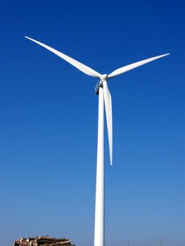portrait of wind turbine in blue sky