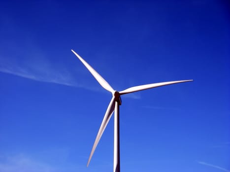 close-up portrait of wind turbine in blue sky