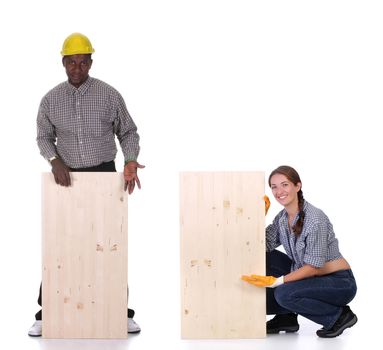 Young african american carpenter and woman carpenter holding wooden plank 