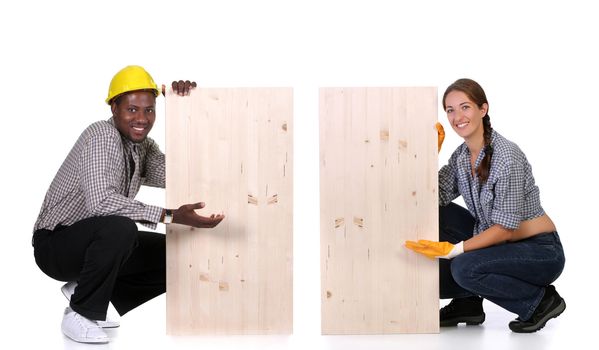 Young african american carpenter and woman carpenter holding wooden plank 