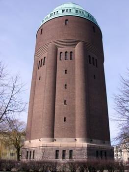portrait of huge water tower in blue sky