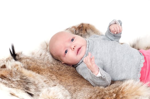 Shot of little cute baby in lying on fur