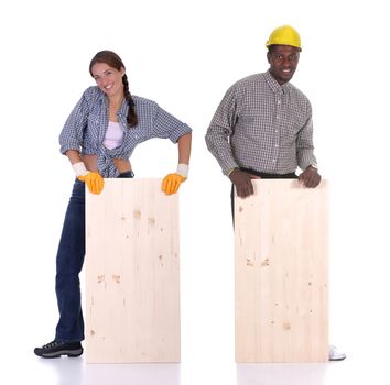 Young african american carpenter and woman carpenter holding wooden plank 