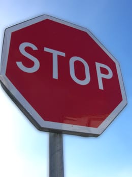 portrait of stop sign in blue sky