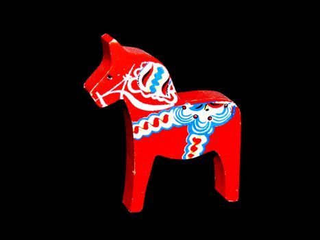 portrait of original swedish dala horse on black background