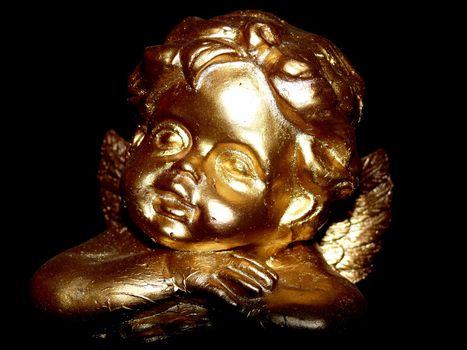 portrait of angel in gold statue on black background