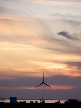 portrait of wind turbine in beautiful sunset