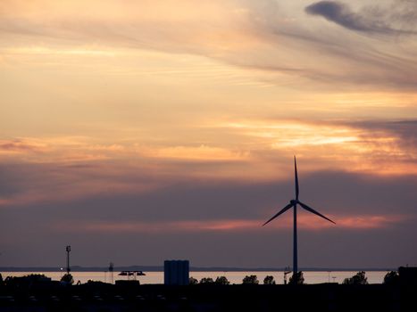 portrait of wind turbine in beautiful sunset