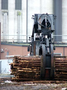 portrait of truck loading timber to a boat