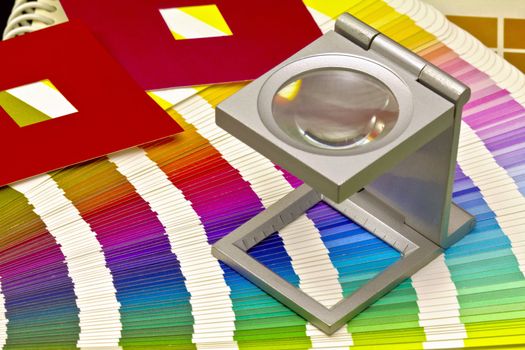 Color guide for offset print with a magnifier lens over the table