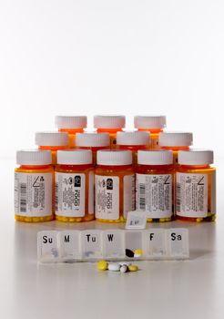 Vertical row of prescription drug bottles with a tablet holder