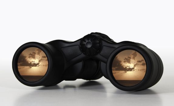 Binoculars showing a rosy sunset giving an illustration of a secure future or a happy retirement