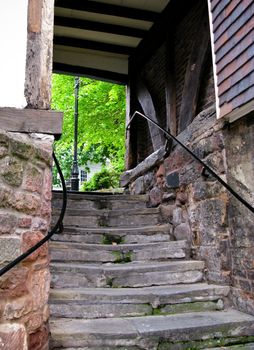 View up ancient stone steps in Shrewsbury in Shropshire leading to leafy area