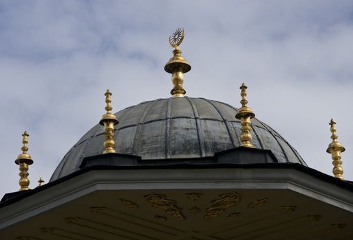 Golden minarets on the roof of a mosque in Istanbul