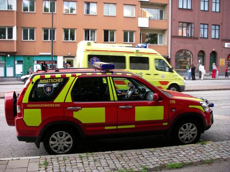 portrait of fire boss vehicle and ambulans on alert in background