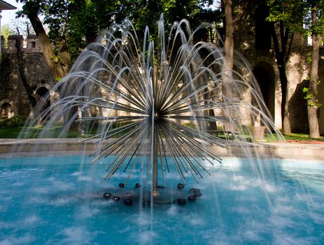 Modern fountain in the gardens in the old city of Istanbul with the water blurred with time exposure