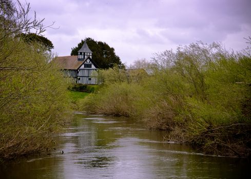 Reflection of half-timbered Melverley Church in the adjacent river Vrynwy