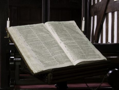 Close -up of the old church bible in Melverley Church in Shropshire illuminated by candles