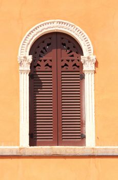 beautiful windows and a orange wall in piazza Signoria, Verona, Italy