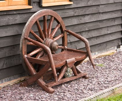 Rustic wooden chair made from an old cart wheel