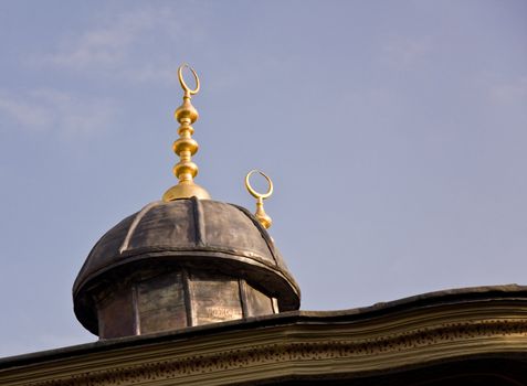 Detail of the golden spires and circular shapes on the roof of building in Istanbul