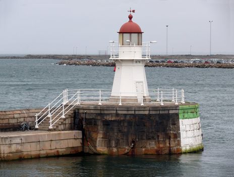 portrait of an old lighthouse on gray sky