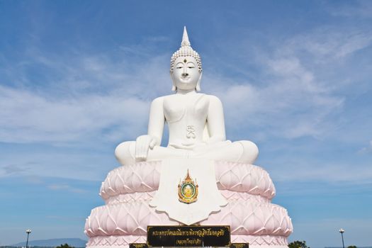 White Buddha statue with blue sky.