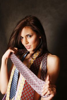 Portrait of the beautiful brunette with ties in studio