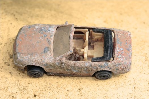 an old rusty toy classic car close up from above