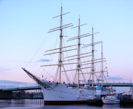 portrait of sail ship in the harbour in beautiful sunset