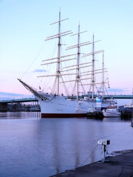 portrait of sail ship in the harbour in beautiful sunset