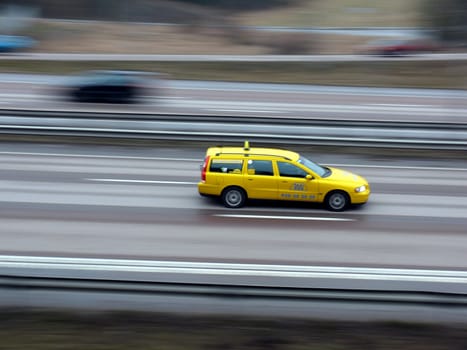 portrait of fast yellow cab motion blur
