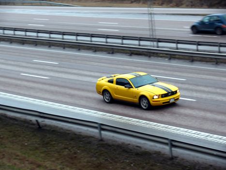 portrait of speeding sport car on motorway motion blur