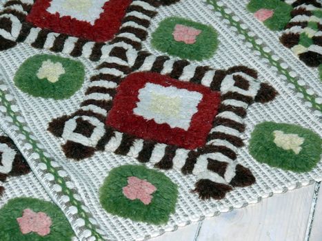 portrait of colorful carpet and white wooded floor