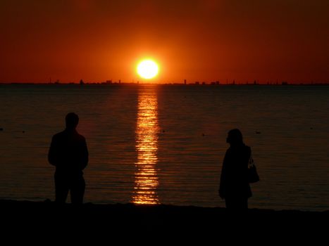 portrait of midnight sun infront man and woman enjoy the landscape