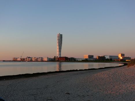 portrait of turning tower building with reflections in water