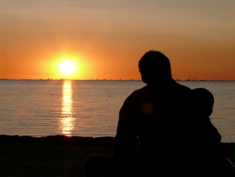 portrait of midnight sun infront man and child