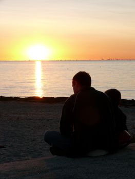 portrait of midnight sun infront man and child