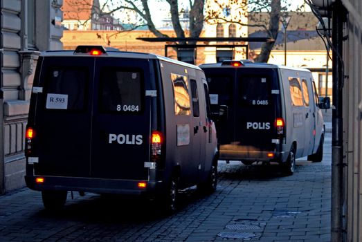 portrait of two armored police vans on watch