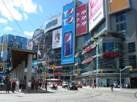 Yonge-Dundas Square by beautiful weather. This place is a large gathering space in the middle of the main shopping area of Toronto, which is the largest city in Canada.