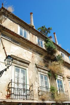 rusty building facade with antique lamp on the wall