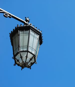 old vintage lantern against blue sky background